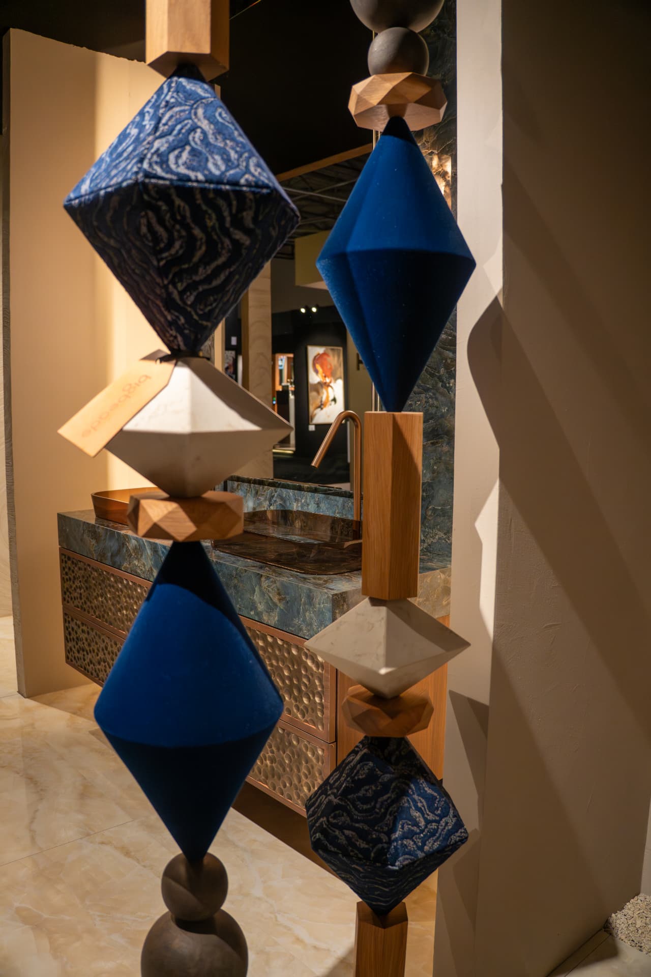 Blue flocked and jacquard beads beside a marble vanity