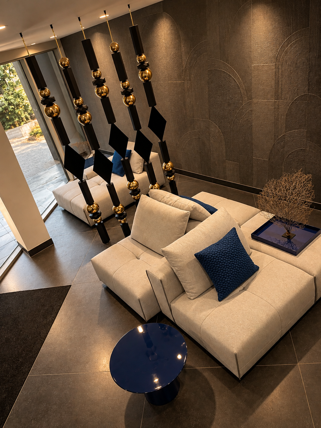 Empress strands with black wood and gold spheres in a lobby