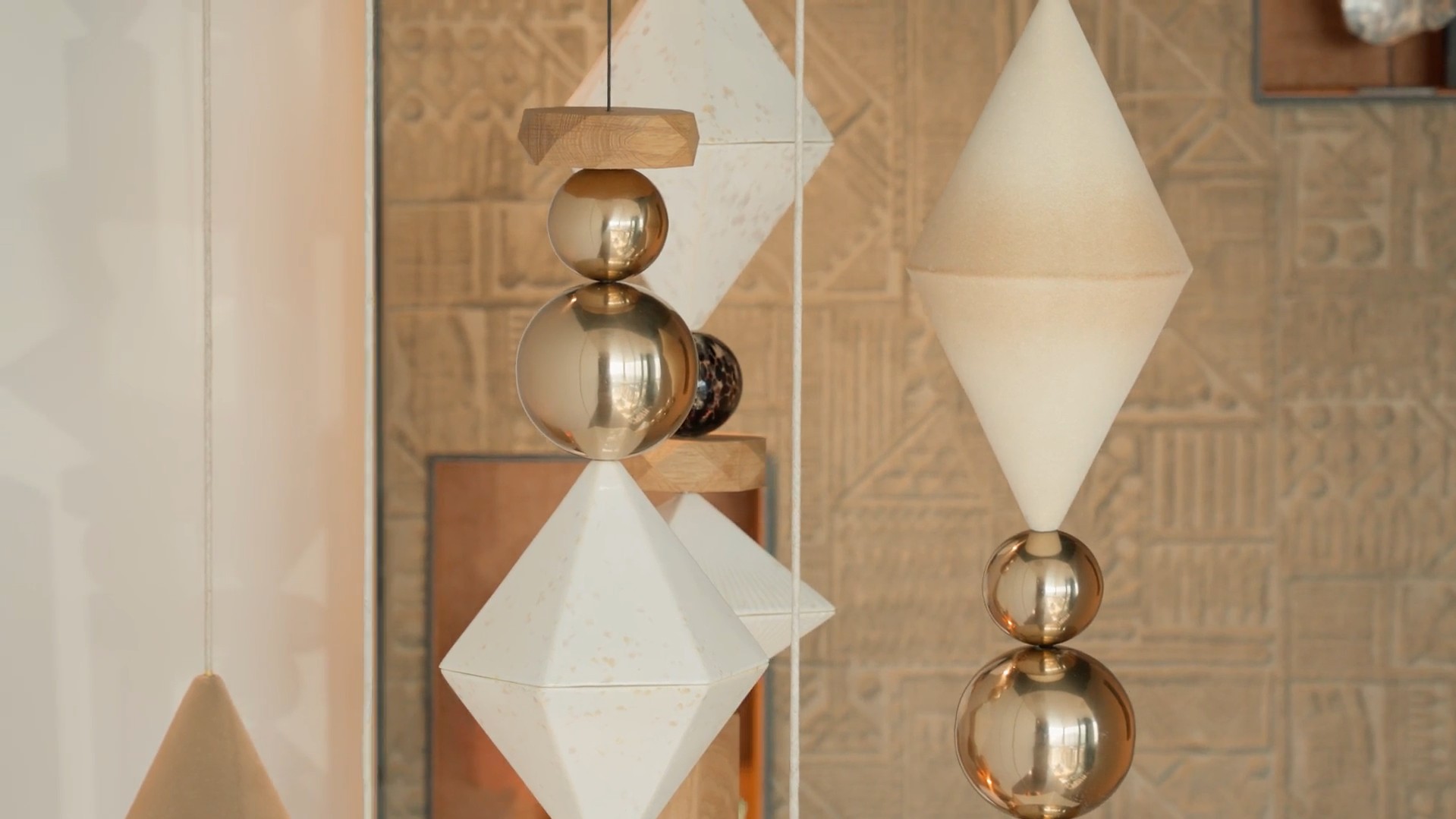 Gold and ceramic BigBeads strands against a carved wall